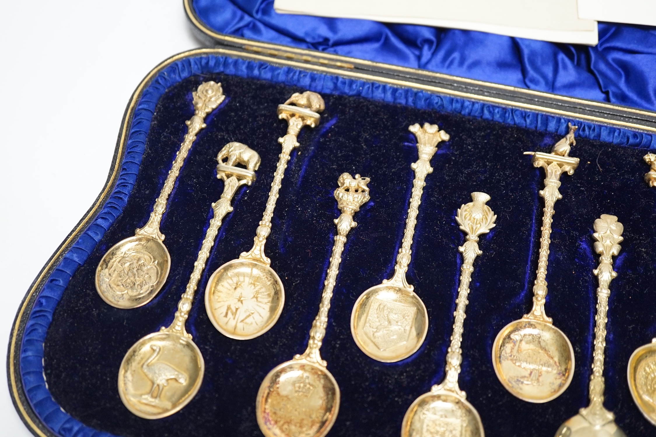 A set of twelve Edwardian silver gilt 'Greater Britain' souvenir spoons, Edward Barnard & Sons, London, 1902, 12.1cm, 8.4oz.